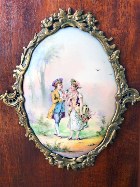 A mahogany cabinet with porcelain panels and brass filigree W.68cm